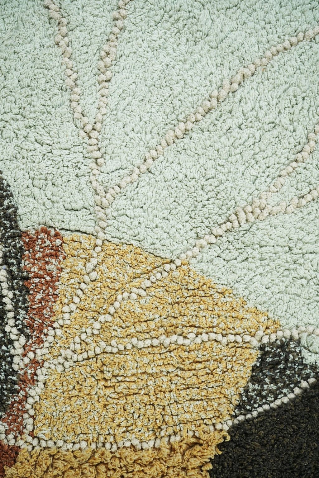 3. Detailed view of bee rug's light blue wing and honey-colored body with intricate stitching