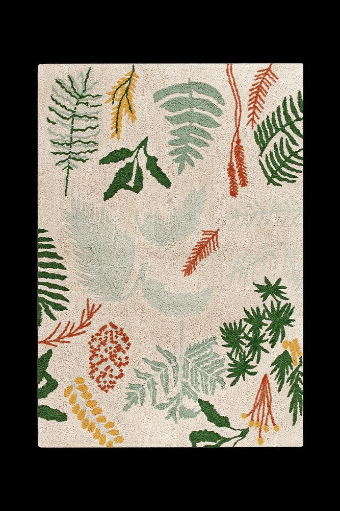 7. Flat lay of a botanical rug with tropical plant designs on a black background