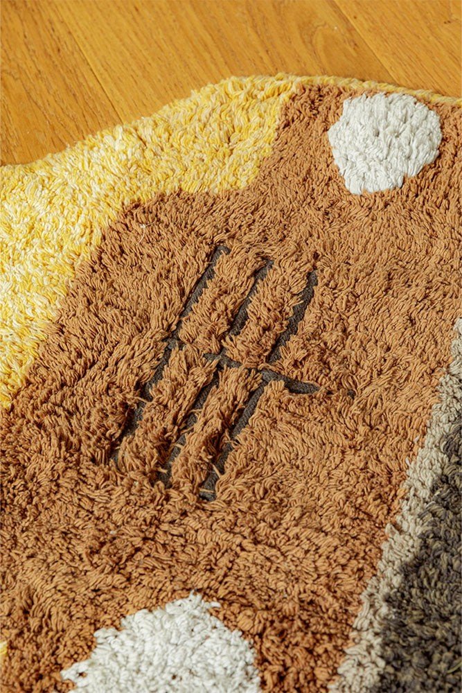 6. Close-up of brown front section of school bus rug, showcasing textured cotton and detailed stitching