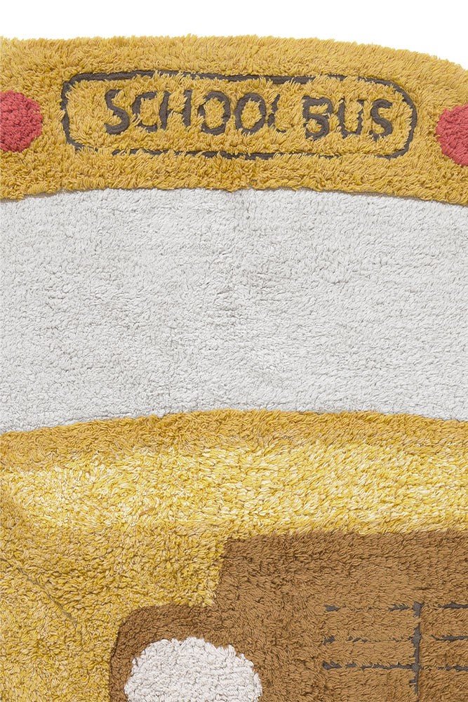 4. Close-up of school bus design on yellow cotton rug, showing embroidered details and layered texture
