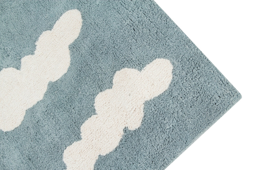 2. Close-up of blue rug corner with white cloud design, highlighting texture and pattern