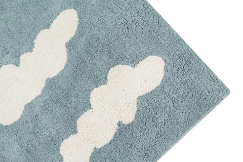 2. Close-up of blue rug corner with white cloud design, highlighting texture and pattern