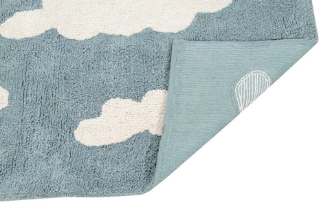 3. Detail of blue rug with white clouds, showing back corner with designer's signature