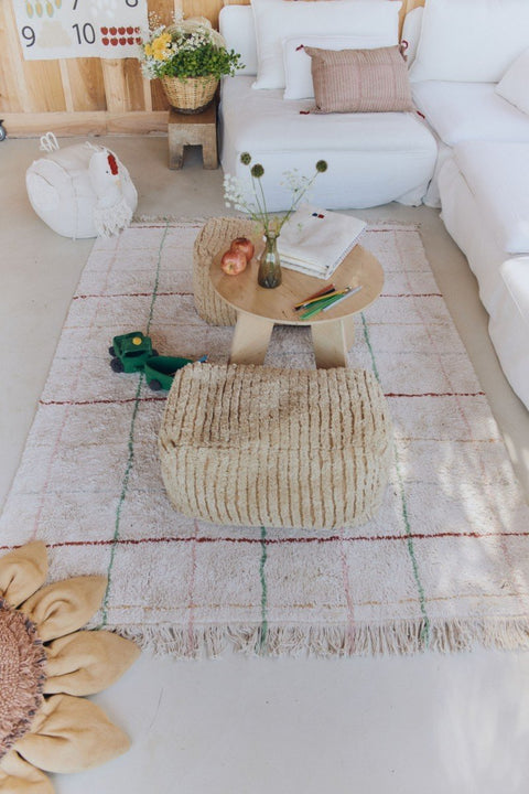 1. Natural multicolor striped rug in children's play area with white sofa and wooden table