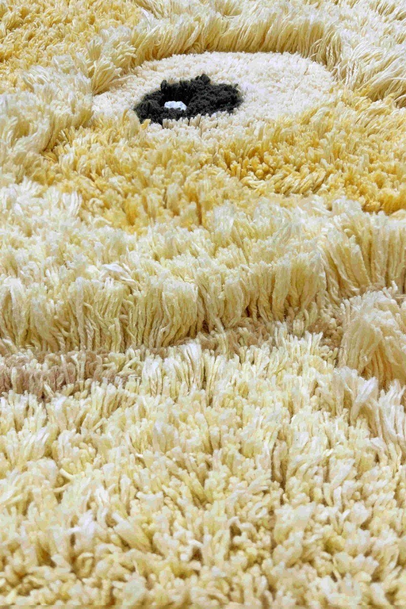 7. Close-up of textured light yellow cotton fibers on duck-shaped rug