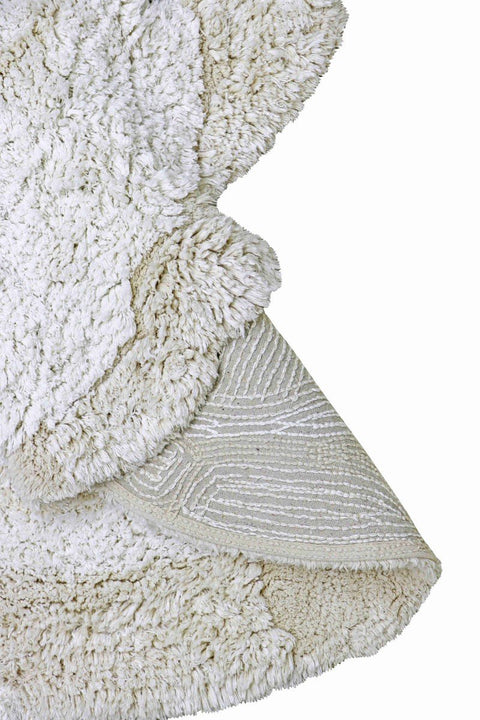 2. Close-up of the underside of a natural and ivory bunny rug showing textured cotton backing