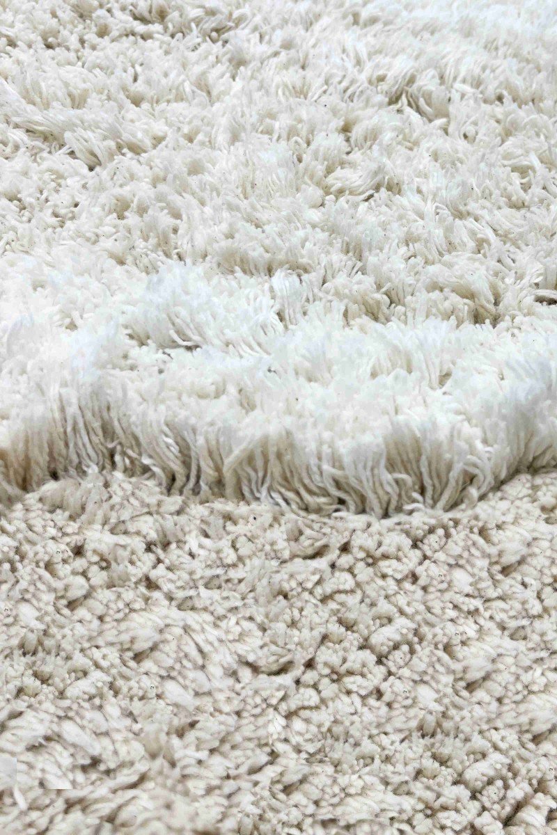 3. Detailed view of the natural and ivory cotton pile texture of the bunny rug