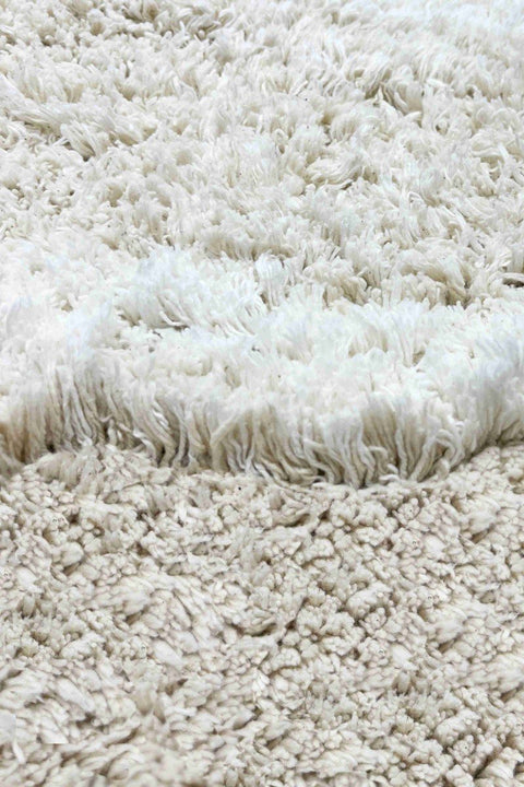 3. Detailed view of the natural and ivory cotton pile texture of the bunny rug