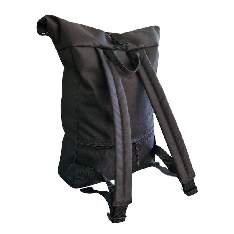 2. Back view of Drinbags waterproof rolltop backpack in black with padded straps, studio setting