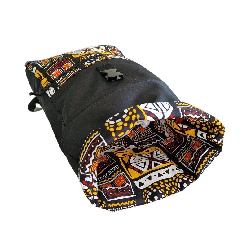 3. Close-up of Drinbags backpack interior showing yellow and orange pattern with rolltop open