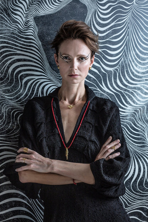 3. Woman in black dress with bold makeup, wearing Flower Of Life Ring, highlighting its elegance