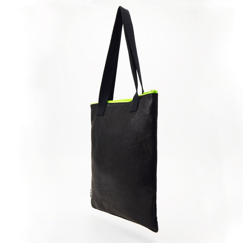3. Side view of Daz Studio black leather tote with neon green zipper and durable construction
