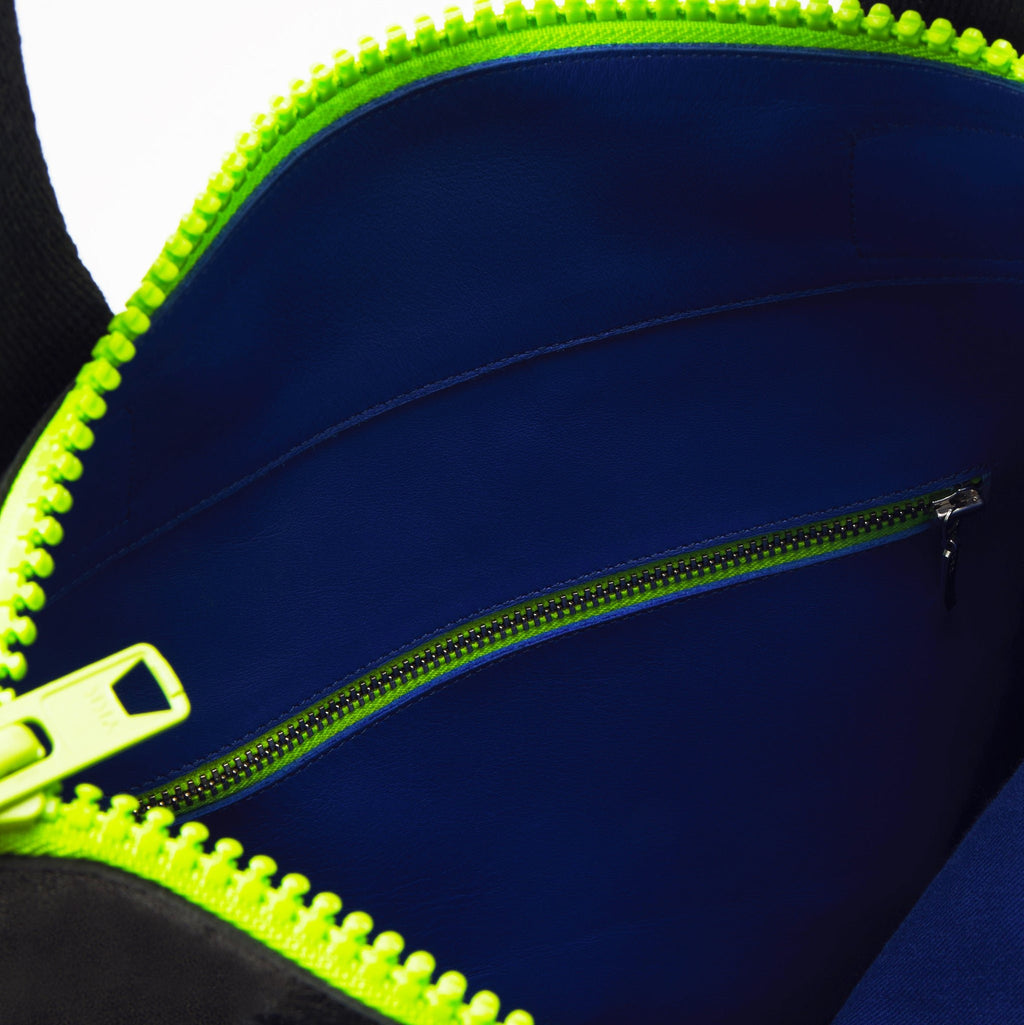4. Close-up of Daz Studio tote interior showing blue leather pocket and neon green zipper