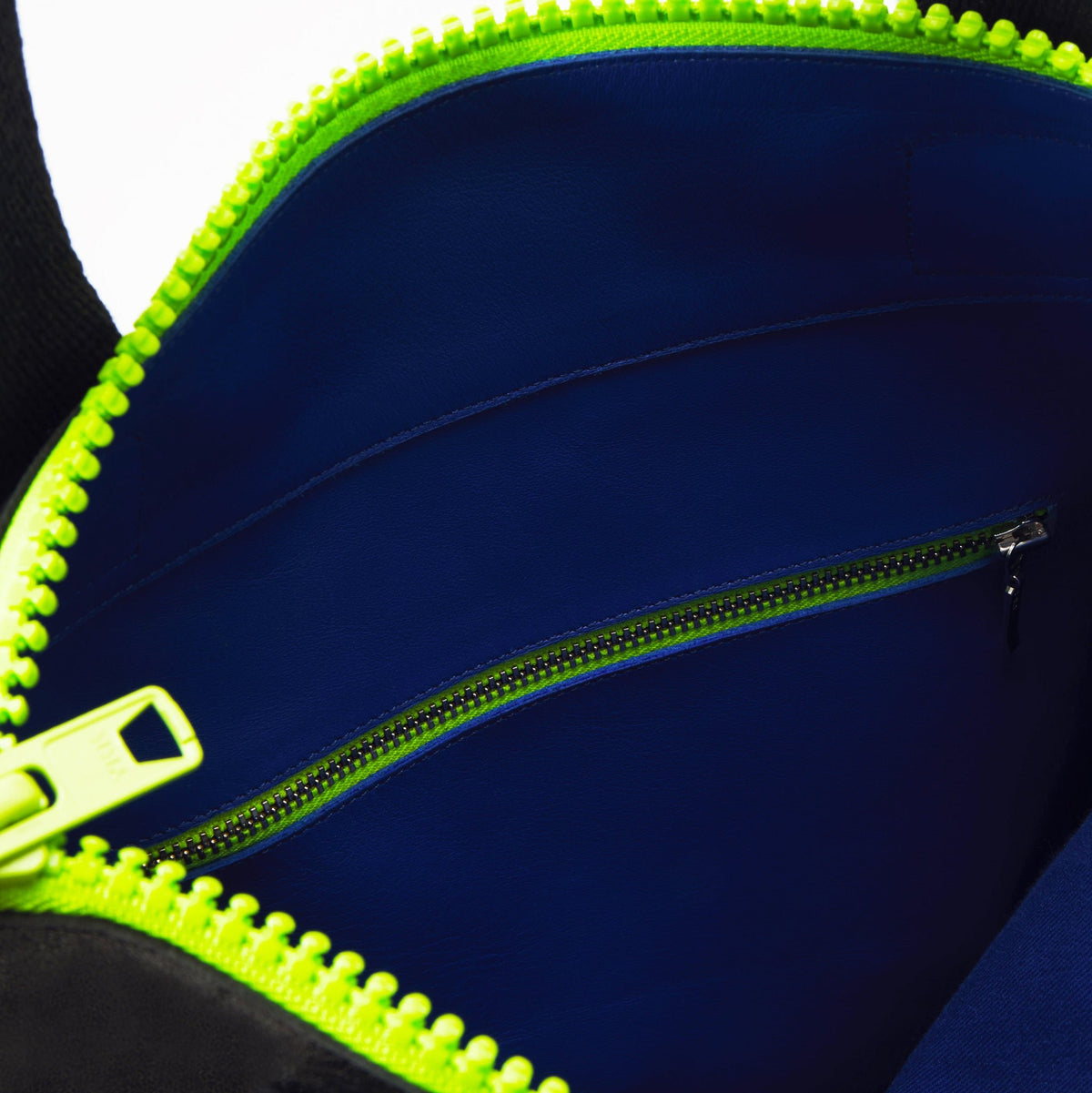 4. Close-up of Daz Studio tote interior showing blue leather pocket and neon green zipper