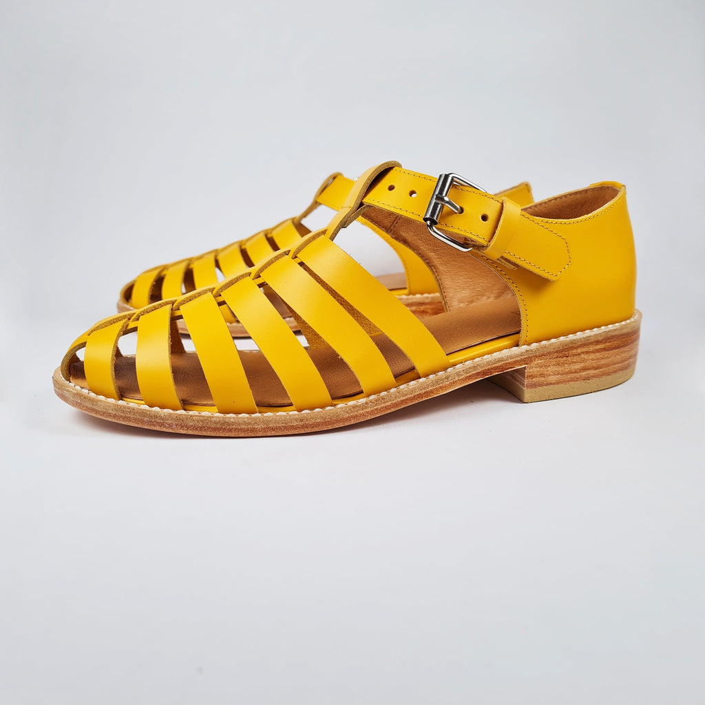 5. Side profile of Daz Studio's yellow leather fisherman sandals with silver-tone buckle