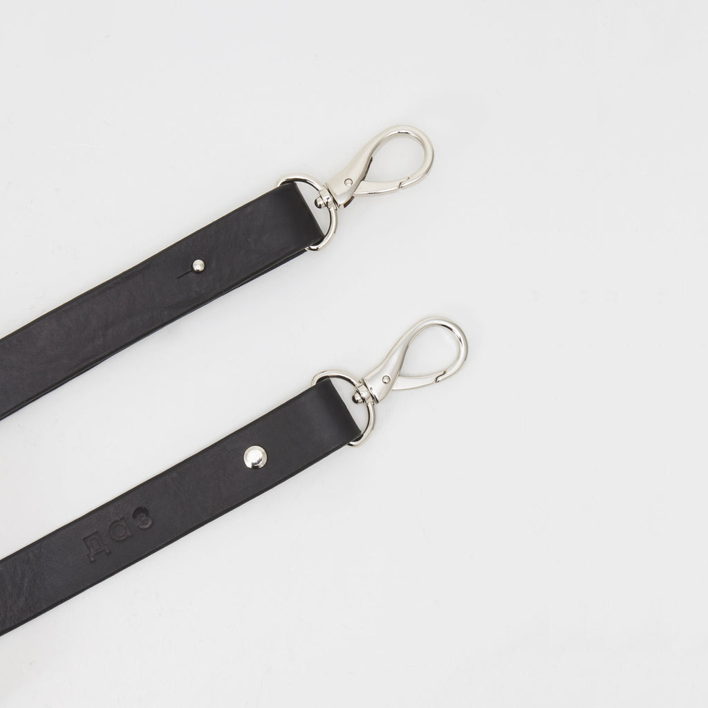 8. Close-up of adjustable leather strap with silver clasps on handmade black leather envelope bag by Daz Studio