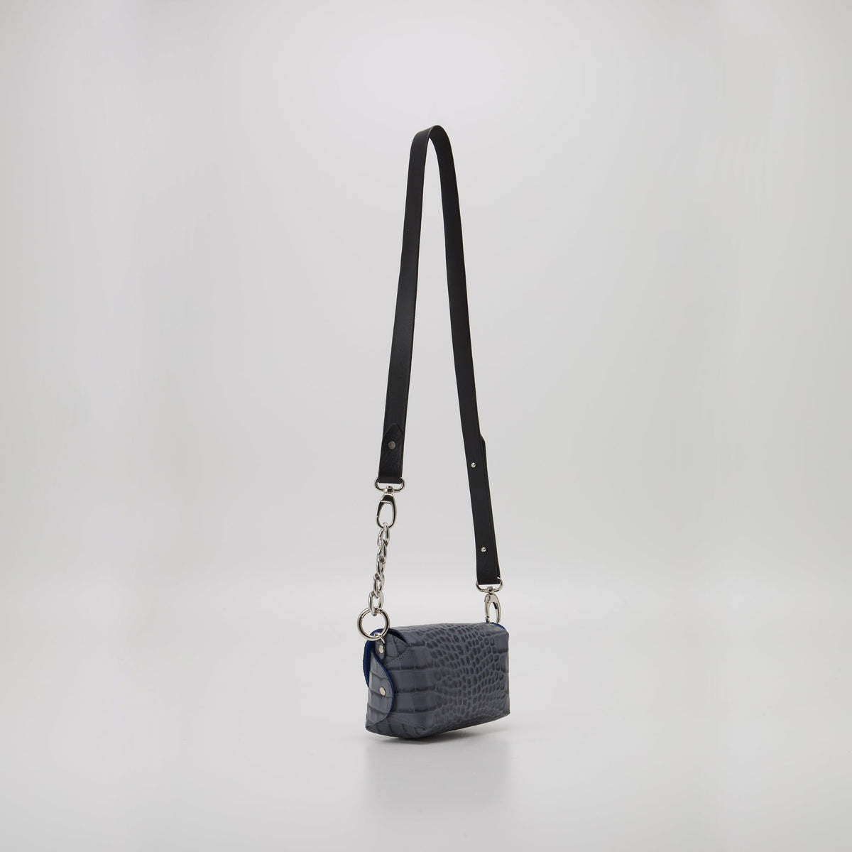 5. Studio image of Daz Studio's grey and blue leather shoulder bag with long adjustable strap, highlighting sleek design