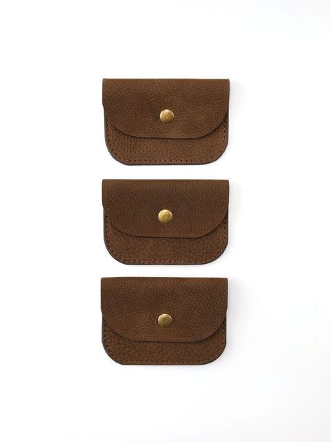 3. Trio of brown nubuck leather wallets with brass buttons displayed vertically on white background