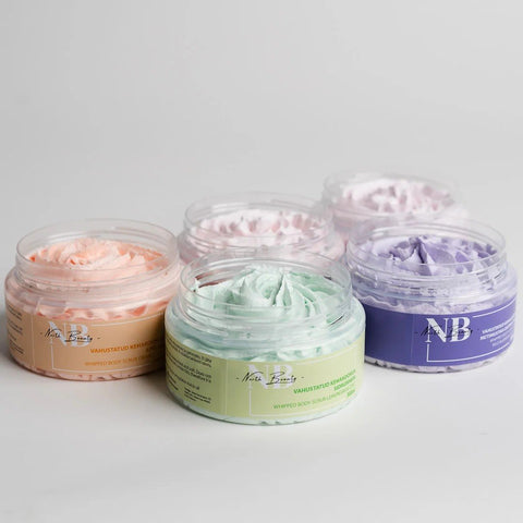 3. Collection of North Beauty Whipped Body Scrubs in various colors, displayed in jars