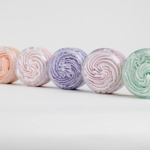 2. Assorted North Beauty whipped sugar body scrubs in various colors, shown from top view in studio setting