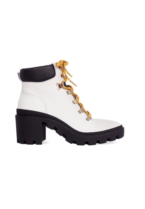 2. White combat boots with 9 cm block heel and yellow laces on clean white background