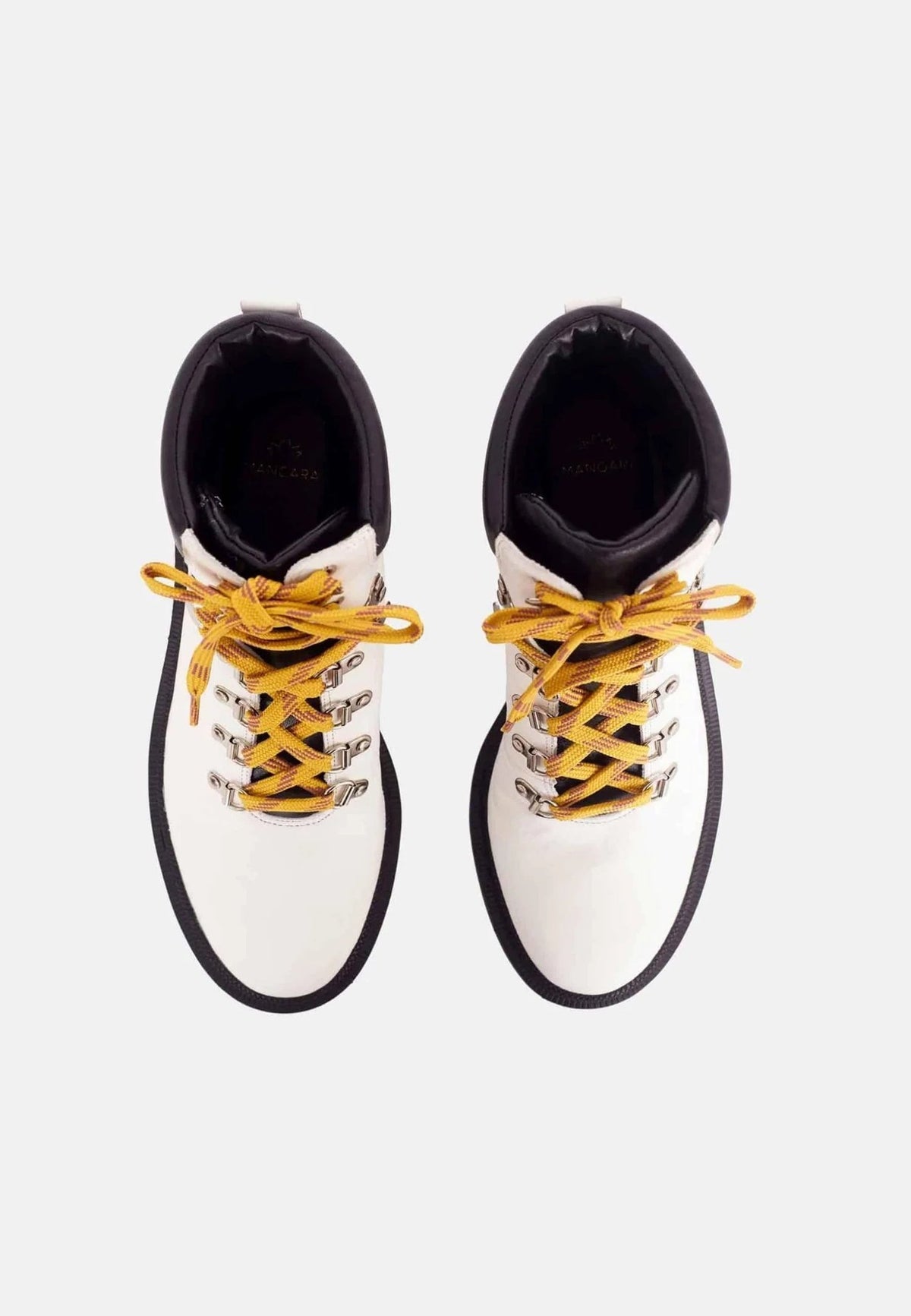 3. Top view of white combat boots with yellow laces and black collar on white background