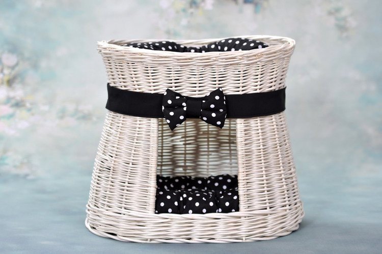 1. Whitewashed wicker cat house with black polka dot cushions and bow, set against a floral background