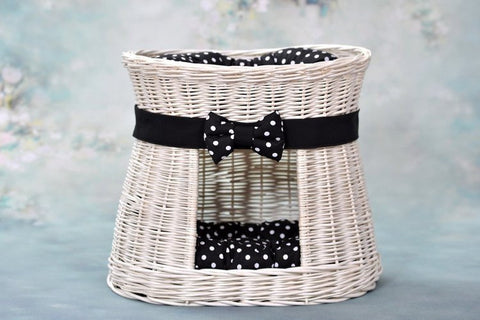 1. Whitewashed wicker cat house with black polka dot cushions and bow, set against a floral background