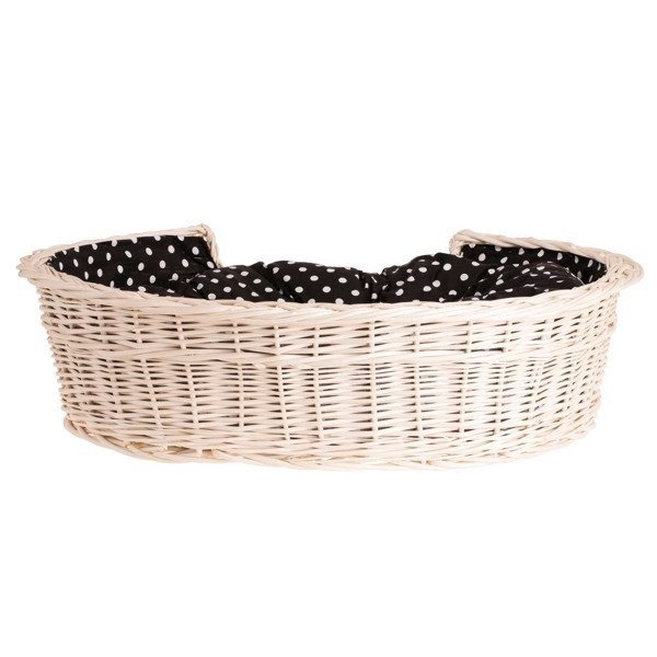 2. Side view of whitewashed wicker dog bed with black polka dot cushion, highlighting handwoven design