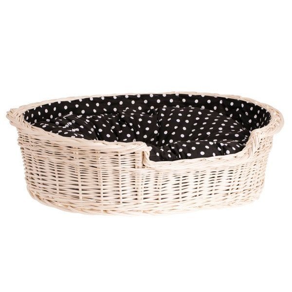 2. Angled view of whitewashed wicker dog bed with black polka dot cushion, showcasing spacious interior