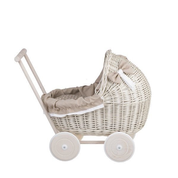 2. Side view of whitewashed wicker doll pram with beige bedding and wooden frame