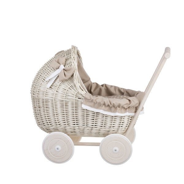 2. Side view of whitewashed wicker doll pram with beige bedding and wooden frame