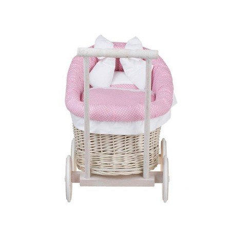 8. Front view of whitewashed wicker doll pram with pink bedding, studio background