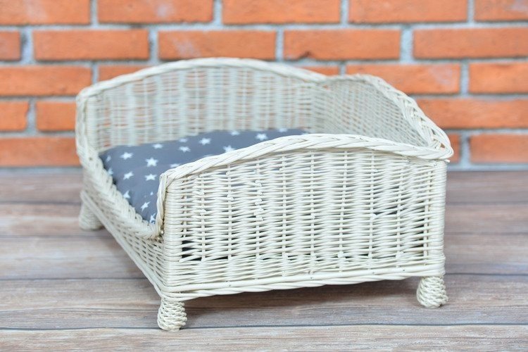 3. Side view of whitewashed wicker pet bed with grey star-patterned cushion
