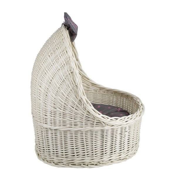 4. Side view of whitewashed wicker pet house with grey cushion and decorative bow