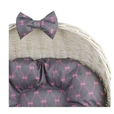 3. Close-up of grey cushion with pink pattern and decorative bow on whitewashed wicker pet house