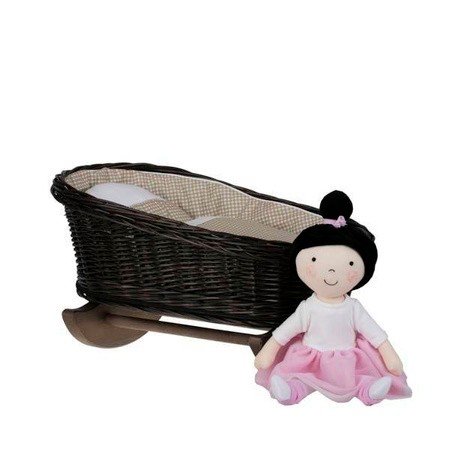 2. Wicker rocking cradle with beige checkered bedding and a doll in pink dress sitting next to it