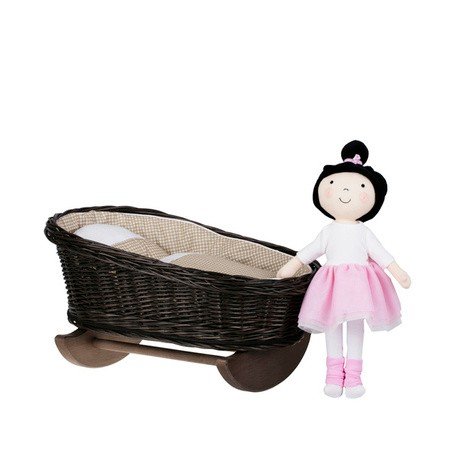 1. Wicker rocking cradle with beige checkered bedding and a doll in pink dress standing beside it