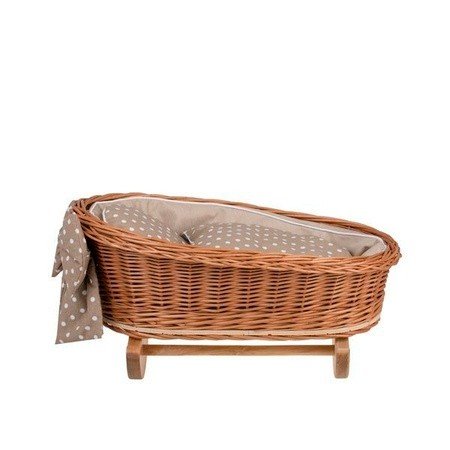 2. Side view of wicker rocking cradle with beige checkered bedding and bow on wooden base