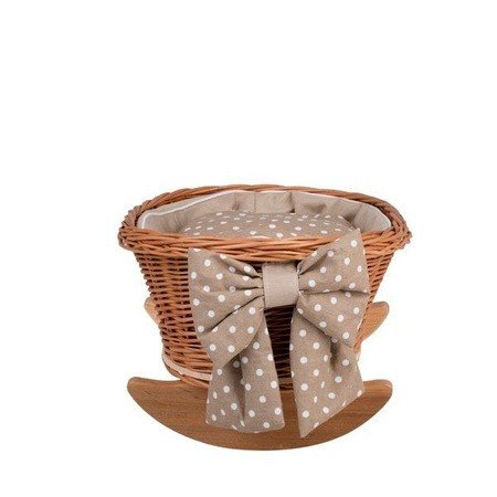 3. Front view of wicker rocking cradle with large beige polka dot bow and checkered bedding