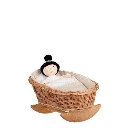 5. Wicker rocking cradle with white bedding and a doll tucked inside