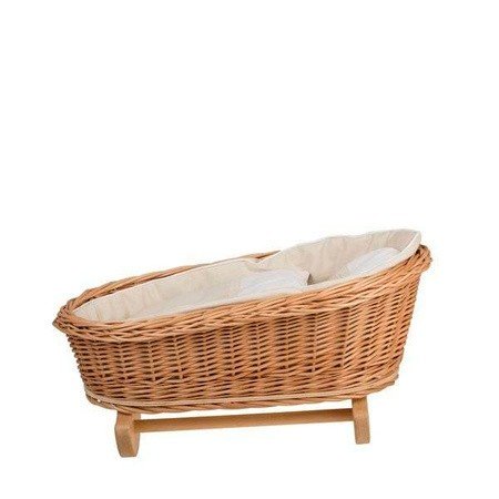 2. Side view of wicker rocking cradle with white bedding on a white background