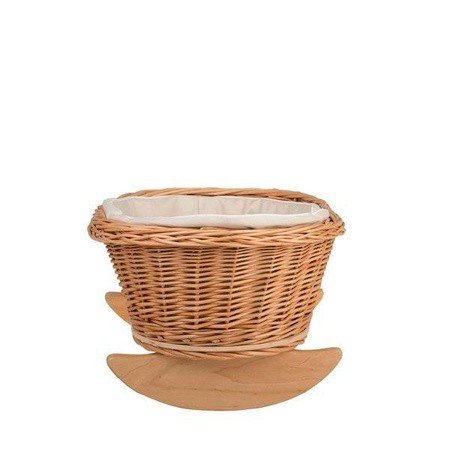 9. Front view of wicker rocking cradle with white bedding on a white background