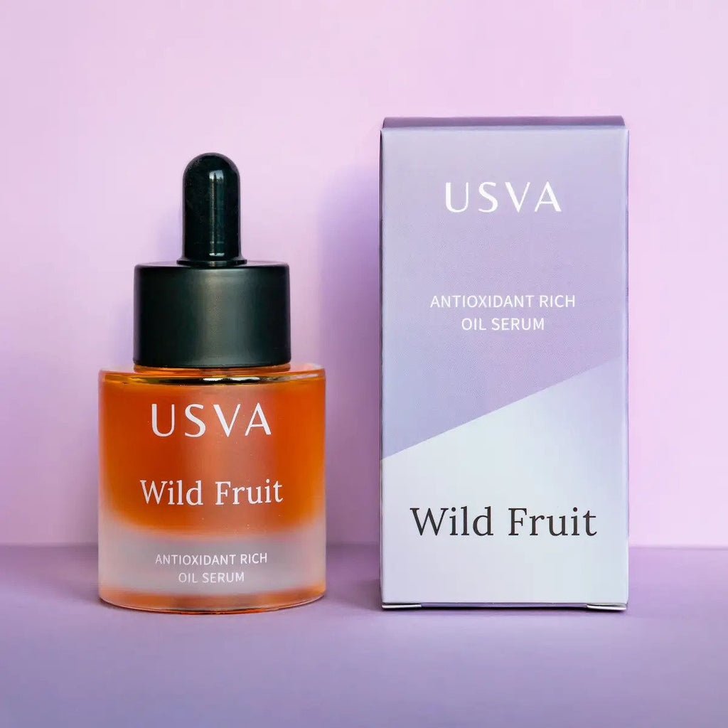 5. Usva Cosmetics Wild Fruit Oil Serum with box on purple background, highlighting product packaging