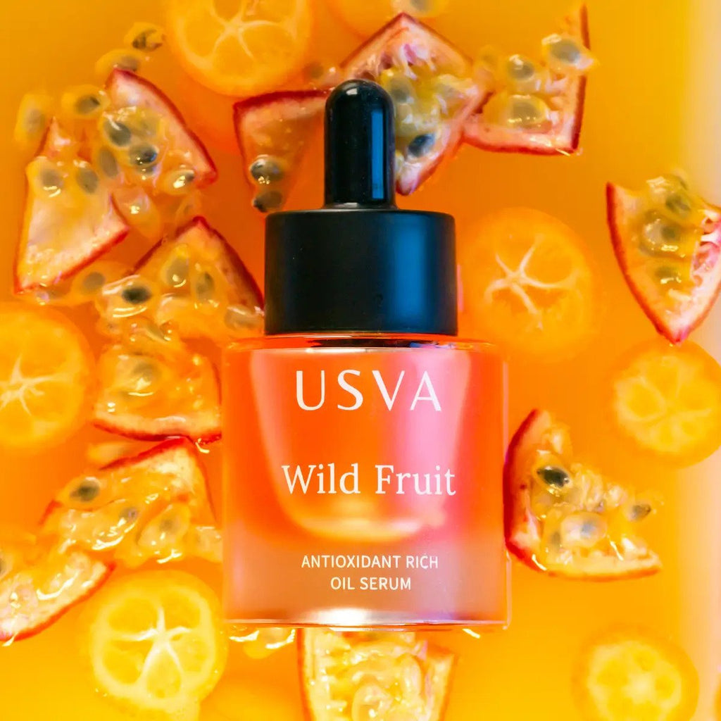 1. Usva Cosmetics Wild Fruit Antioxidant Rich Oil Serum bottle surrounded by fresh fruit slices, highlighting natural ingredients