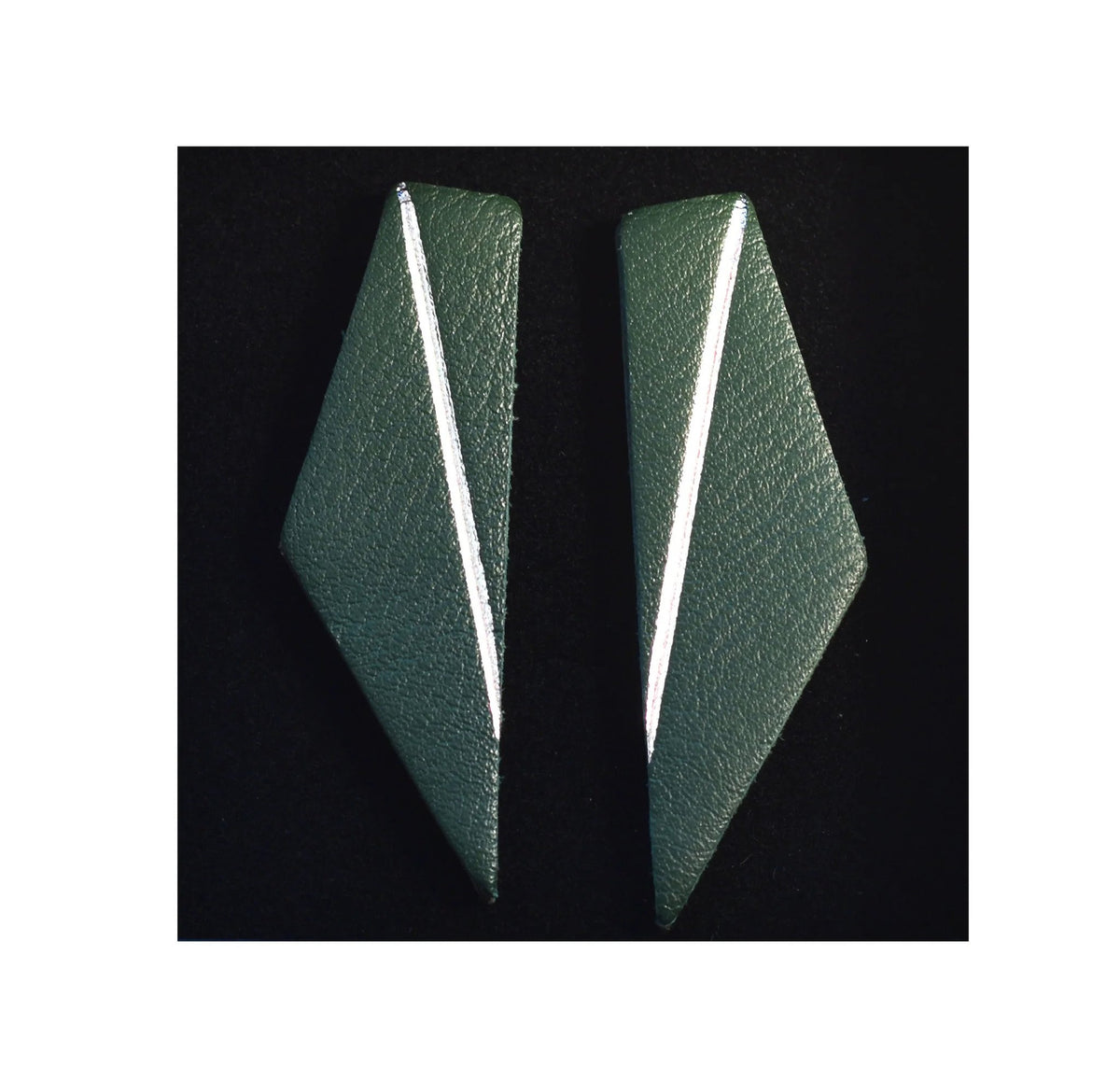 6. Green Gerda Retter Design Short Wings Earrings on black background, emphasizing geometric design