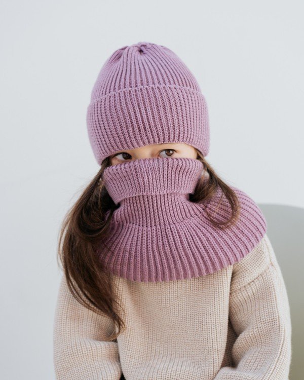4. Child in lilac merino wool hat and scarf covering face in studio setting