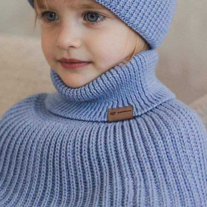 1. Child wearing sky blue merino wool tube scarf and matching hat by Patulove, indoors
