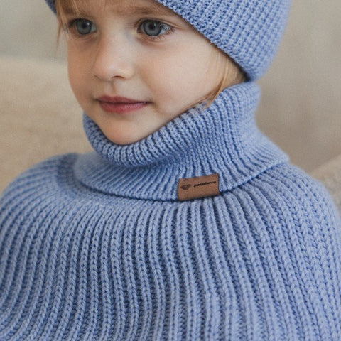 1. Child wearing sky blue merino wool tube scarf and matching hat by Patulove, indoors