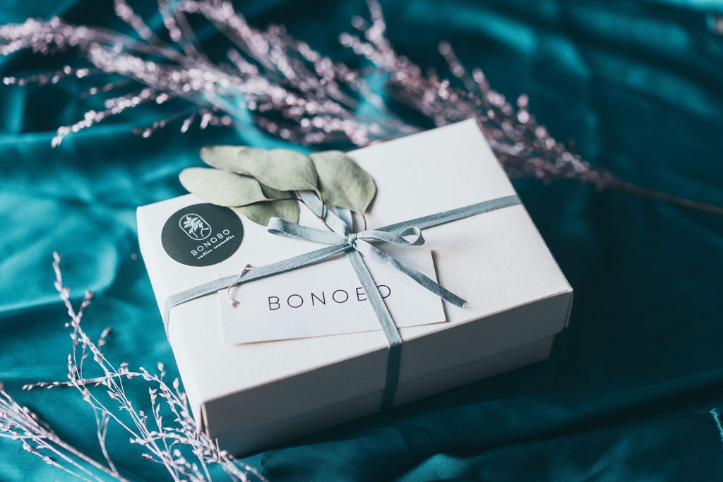 2. Closed BONOBO gift box with eucalyptus decoration and ribbon on teal fabric